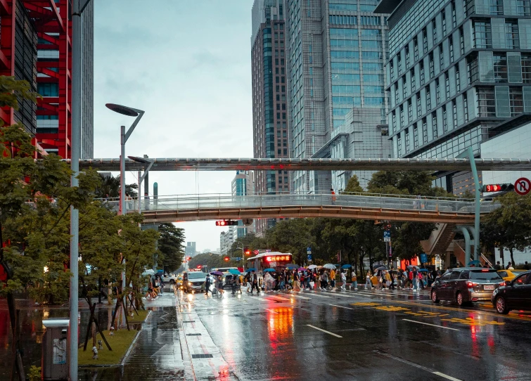 several cars are driving on the street in the rain