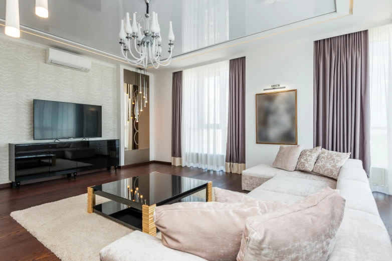 a very big fancy looking living room with a chandelier