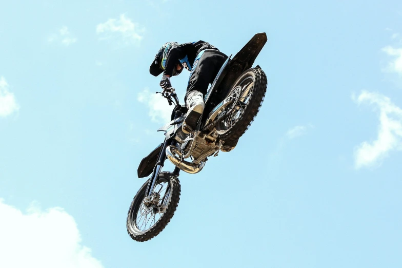 the motocross rider is doing stunts in the air