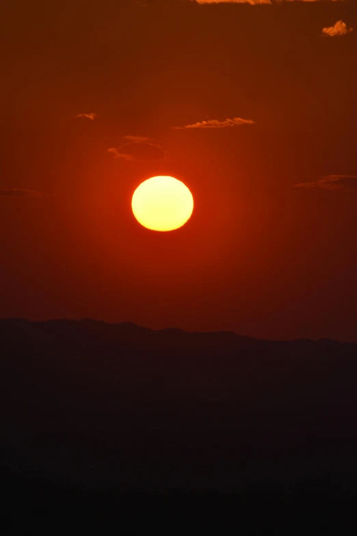 a bright orange and yellow sunset with the sun in the middle