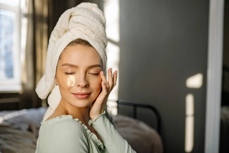 the woman in the towel is using her face to dry