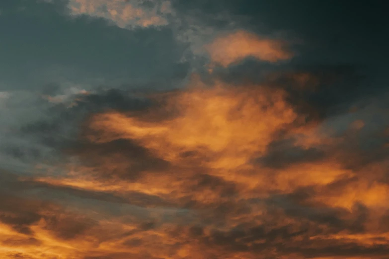 a plane is flying into a sunset at sea