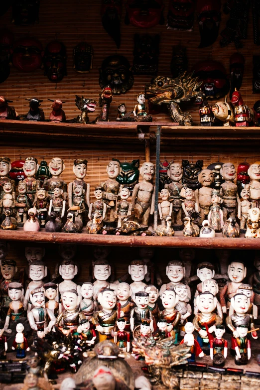 a large number of dolls on shelves for sale