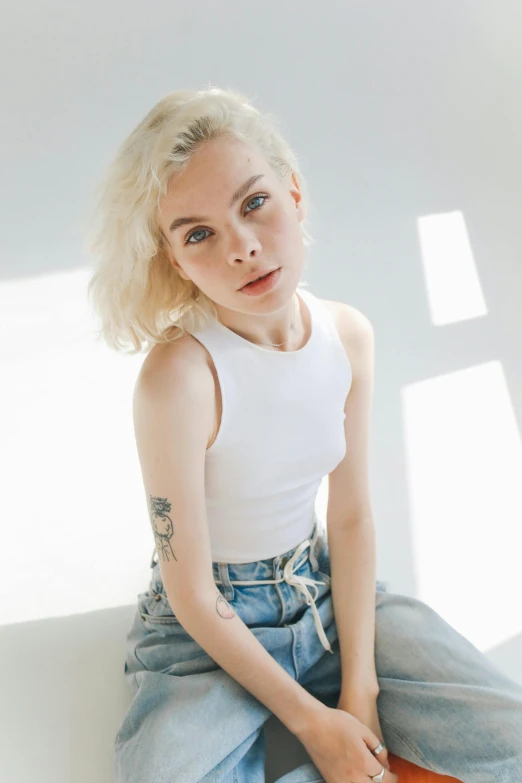 a woman with blonde hair sitting on the floor