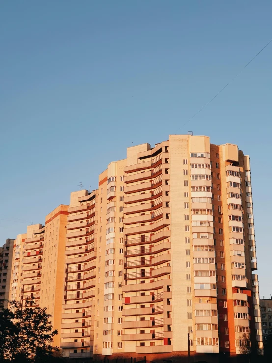 tall brown building with balconies against the sky