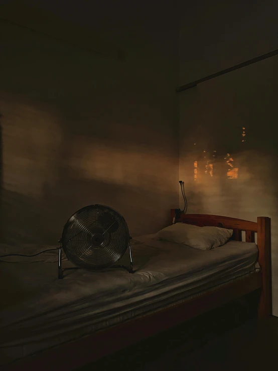 an image of bedroom setting with a fan on the edge