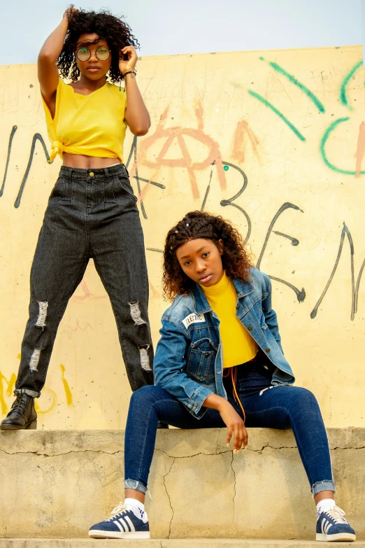 two s sitting on concrete ledges with graffiti