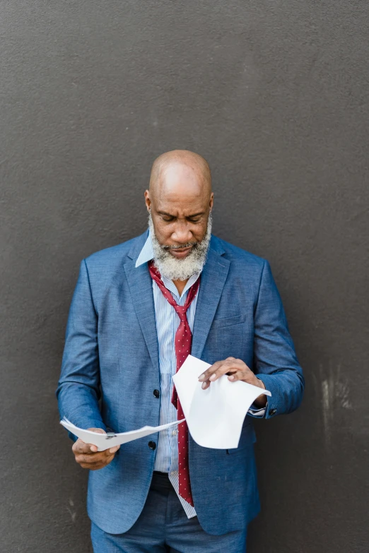 man wearing blue suit and tie  up paper