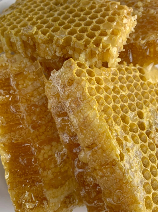 a close - up of honey sticks piled on top of each other