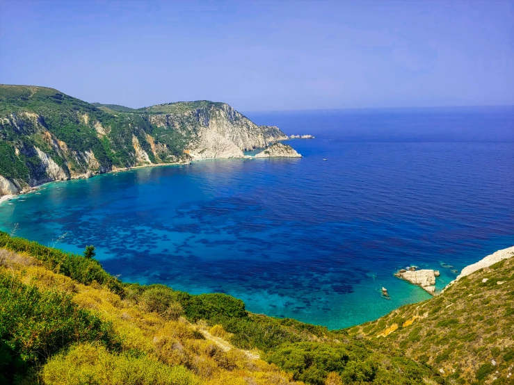 a blue body of water with a beach below it