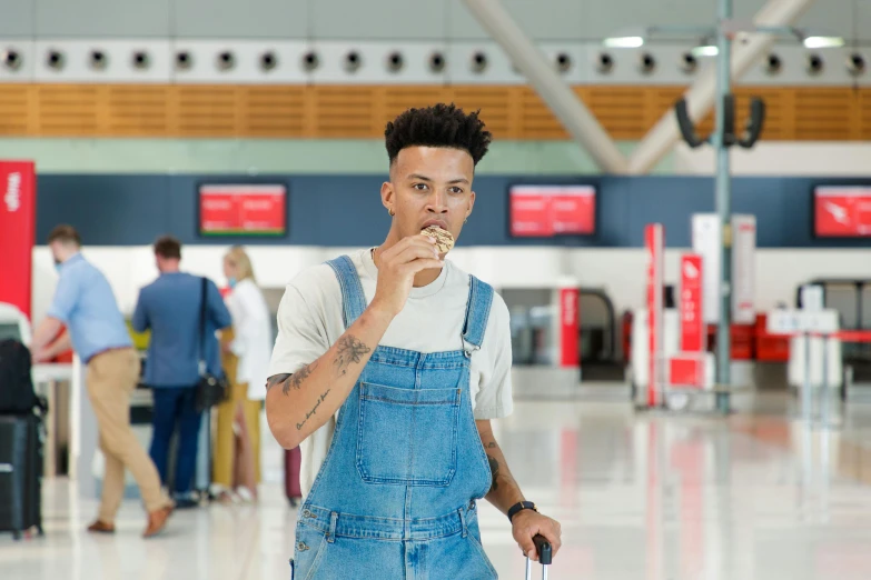 a man smoking while holding a bag of luggage