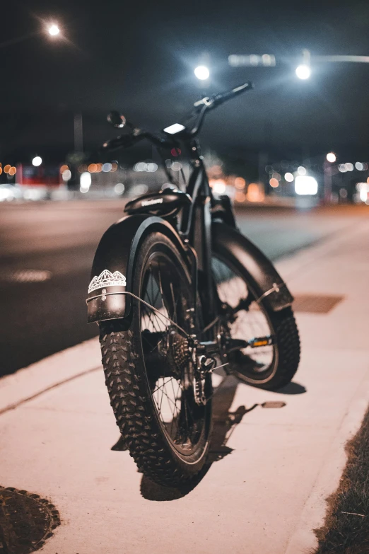 a black motorcycle parked on the side of a street