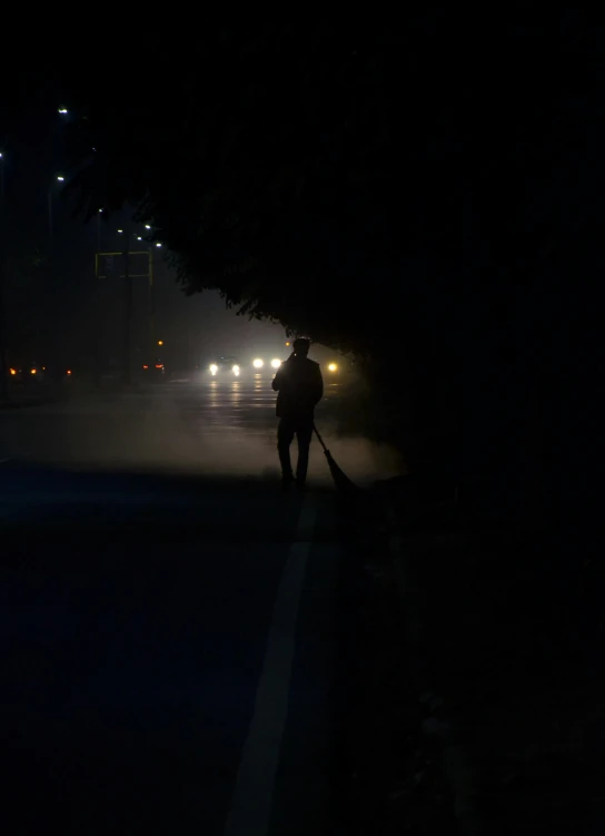 the silhouette of a man at night with a pick up