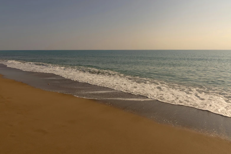 there is a sandy beach near the water