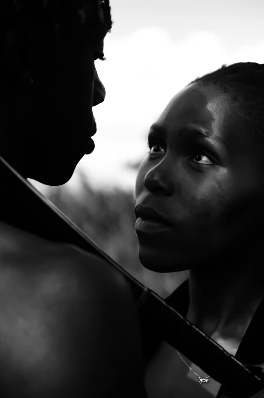 two women look at each other while posing for a po