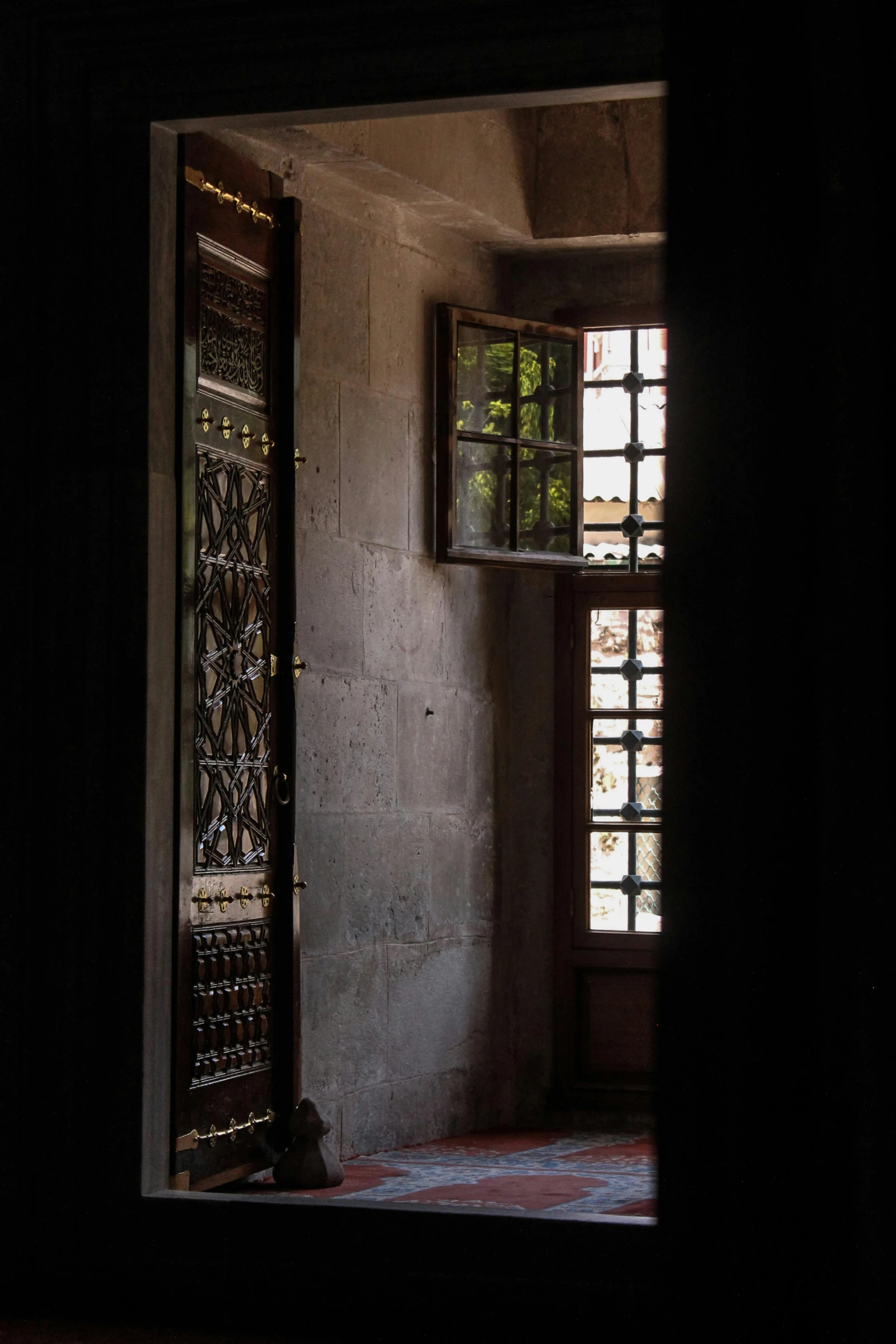 a window with two open doors in an empty room