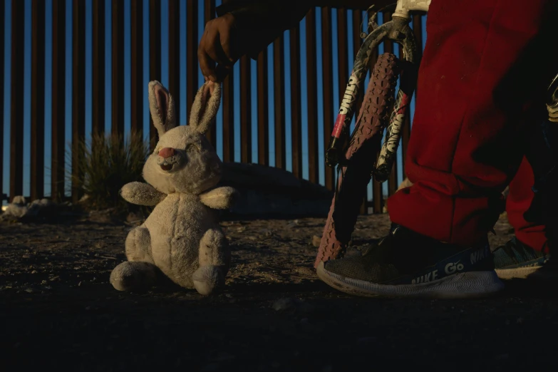 someone has been holding the rope from the white stuffed bunny