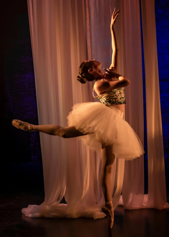 woman in gold dress doing a ballet pose