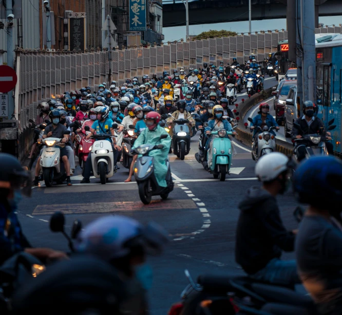 many people are riding their motorcycles on a busy street