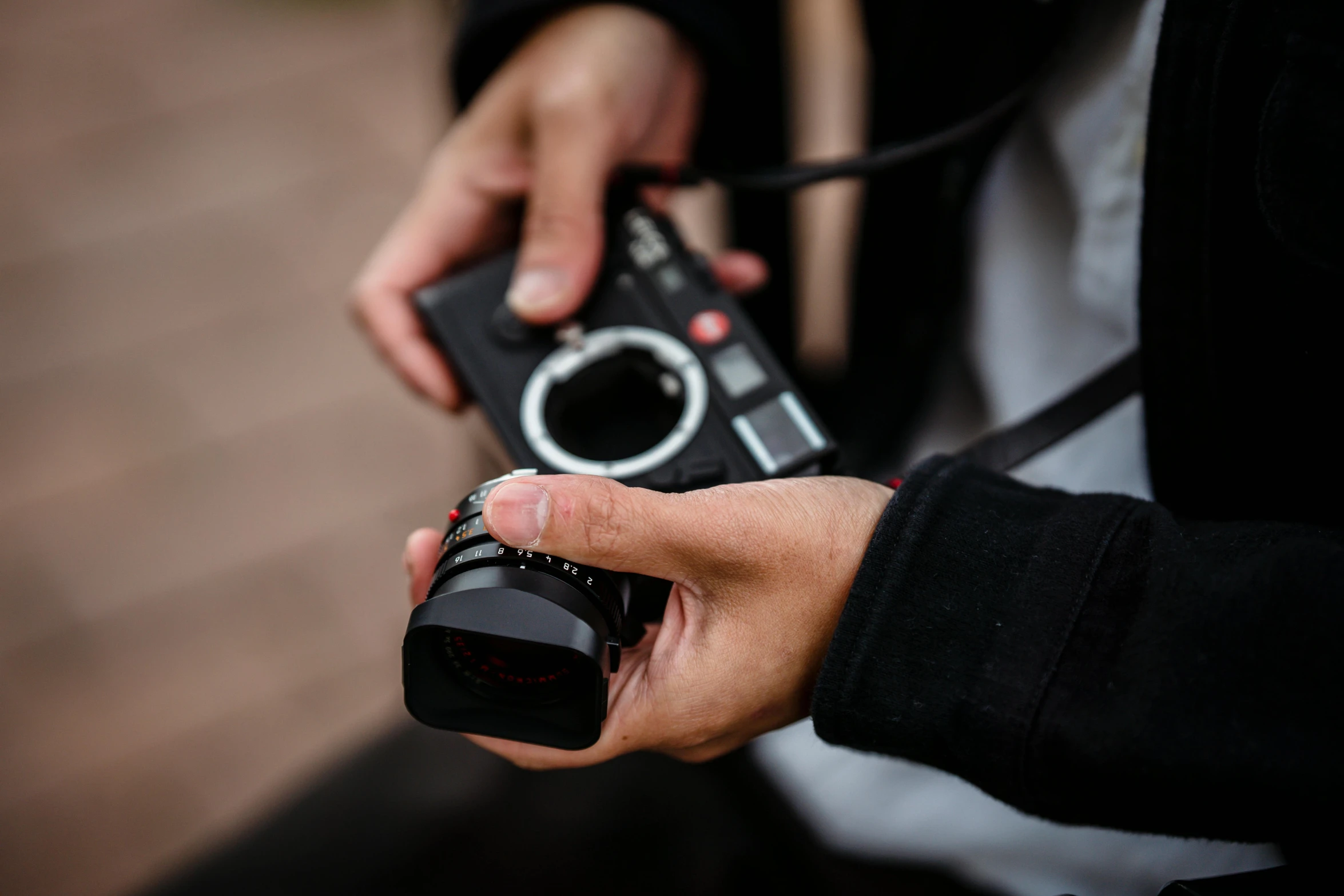 a person holding up a camera near a person's hands