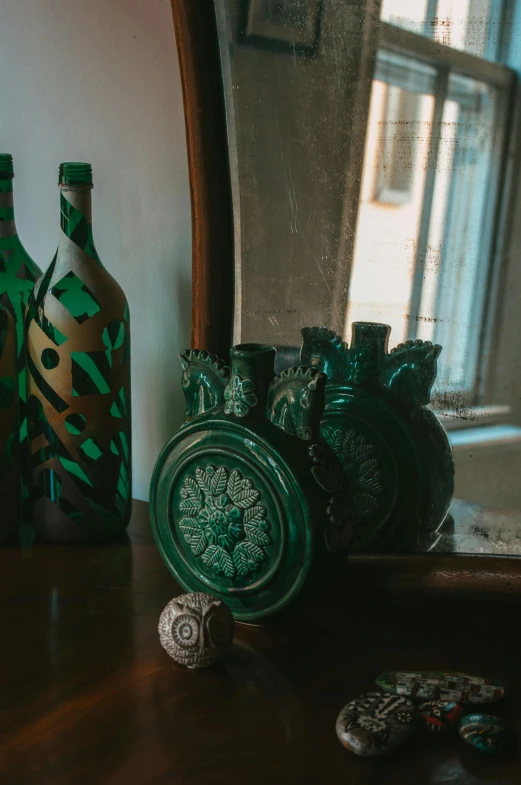 several antique vases and glass bottles sitting on a table