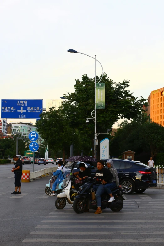 a group of people riding motorcycles on a city street