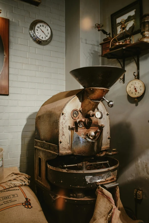 an old coffee machine sitting next to a pile of pillows