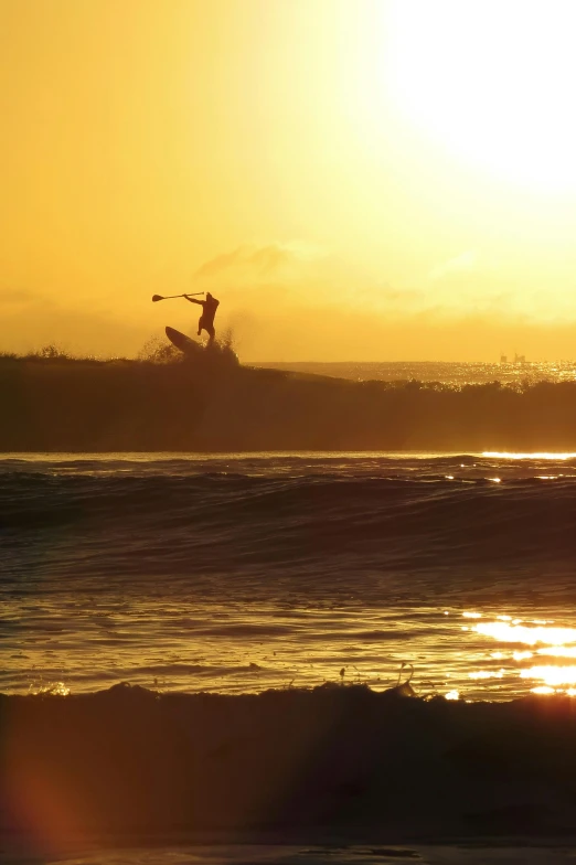 man riding a wave on top of a surfboard on a body of water