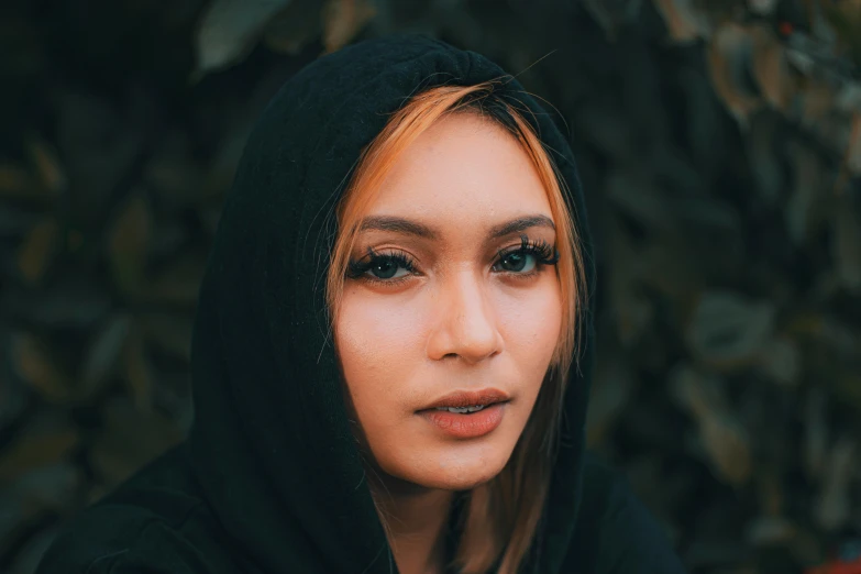 a woman with blue eyes stares at the camera