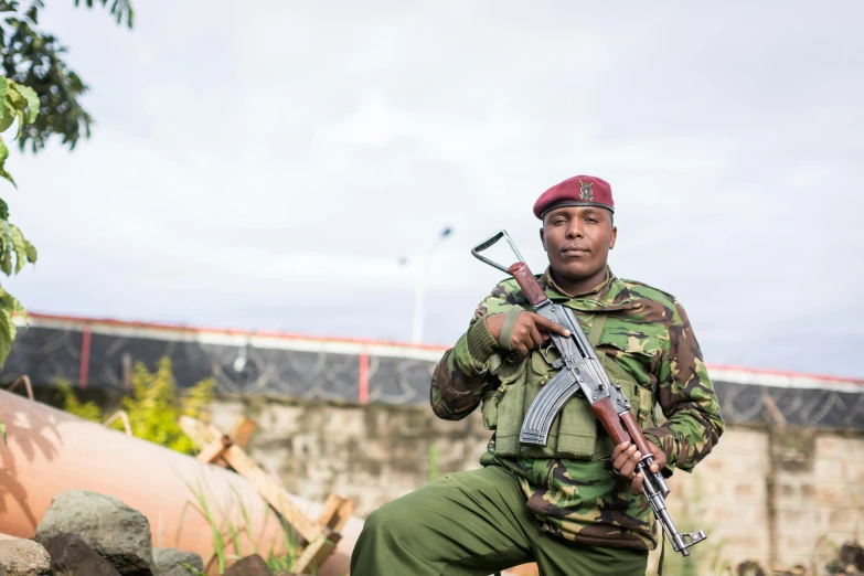 a soldier standing with a gun in his hand