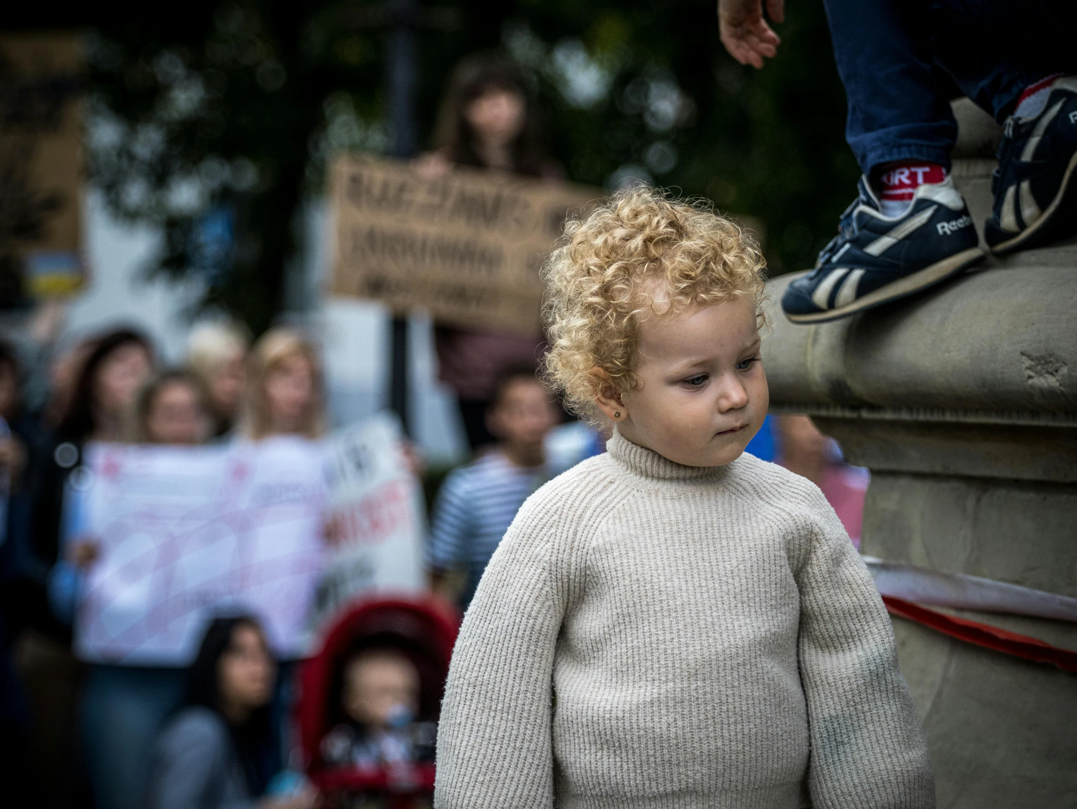 a close up of a child near other children