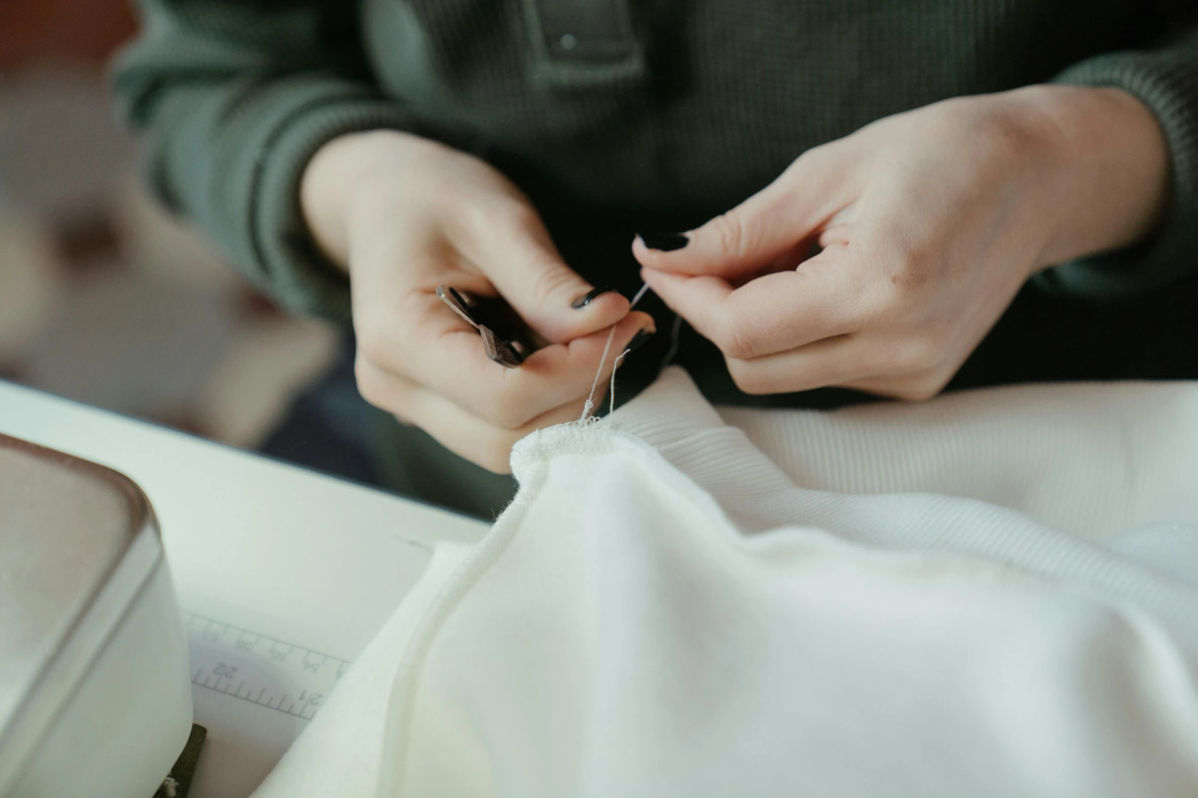 a person is working on sewing soing in a bag