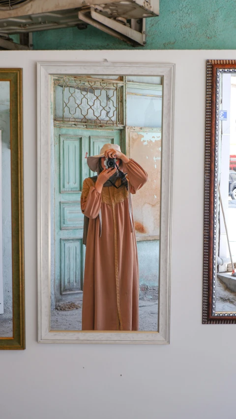 a woman takes a picture of herself in a mirror