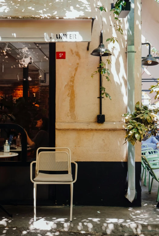 a couple of tables and chairs sitting outside of a building