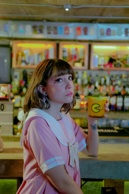 a woman in pink holding up a can