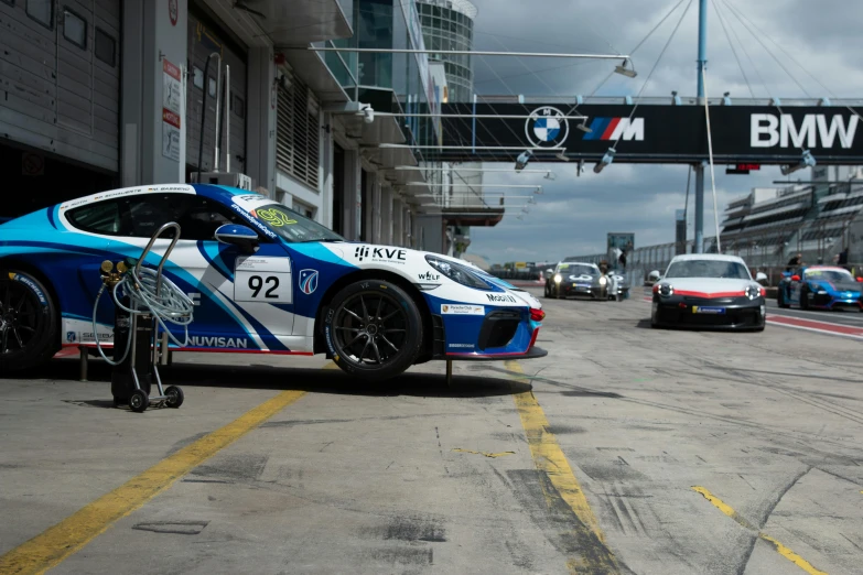 a blue race car is parked in the middle of the street