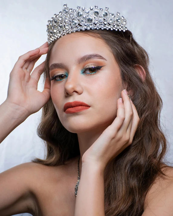 a beautiful young woman wearing a tiara