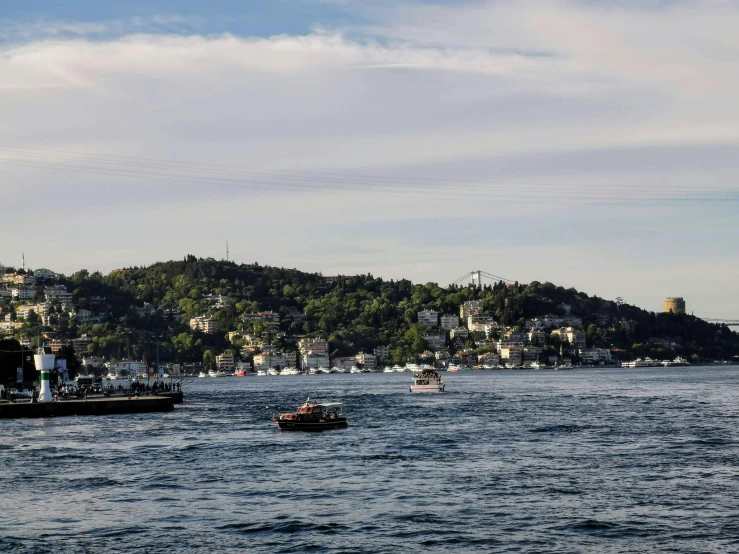 three small boats are sailing on a body of water