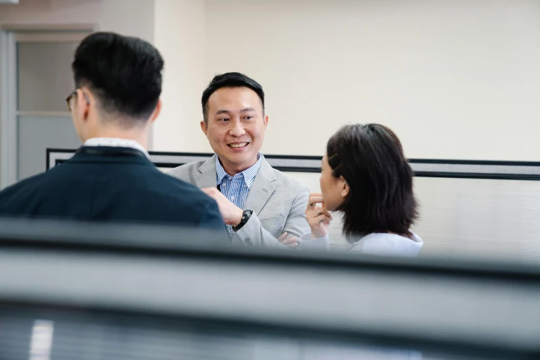 two men and a woman sitting together having conversation