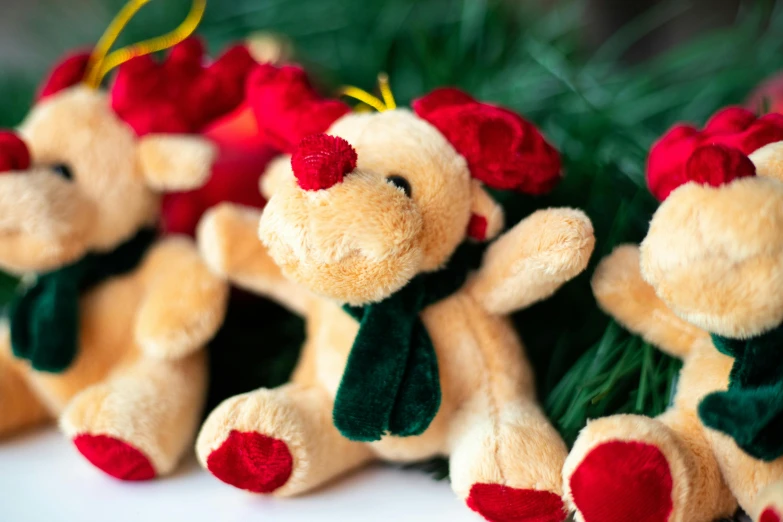 two little stuffed bears with red roses on each