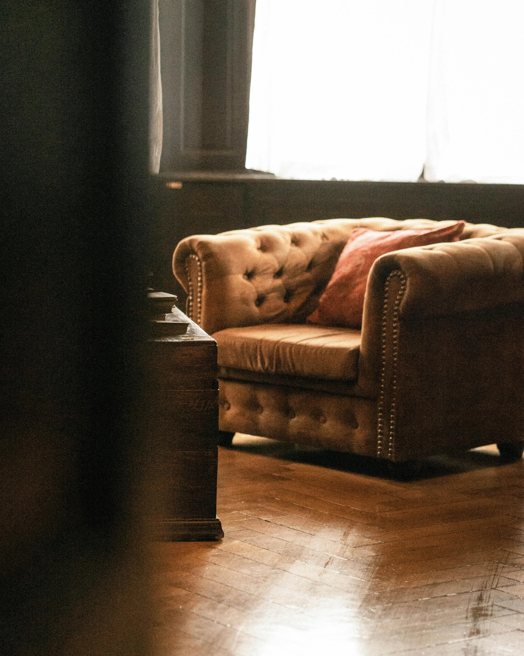 this is a chair with an orange pillow sitting on top of it