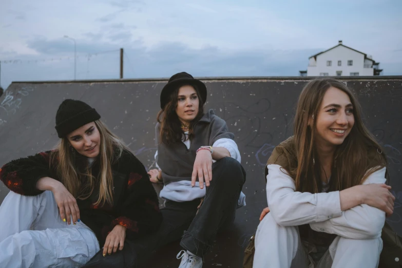 three s sitting next to each other near a skateboard