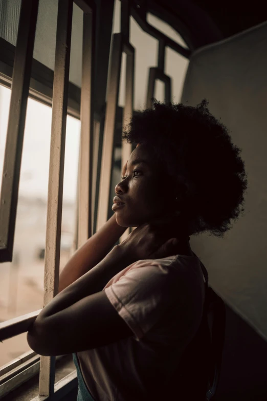 a woman is looking out of the window