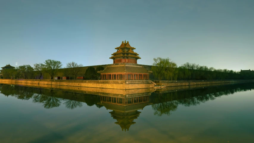 an area with a small building on top that sits in the water