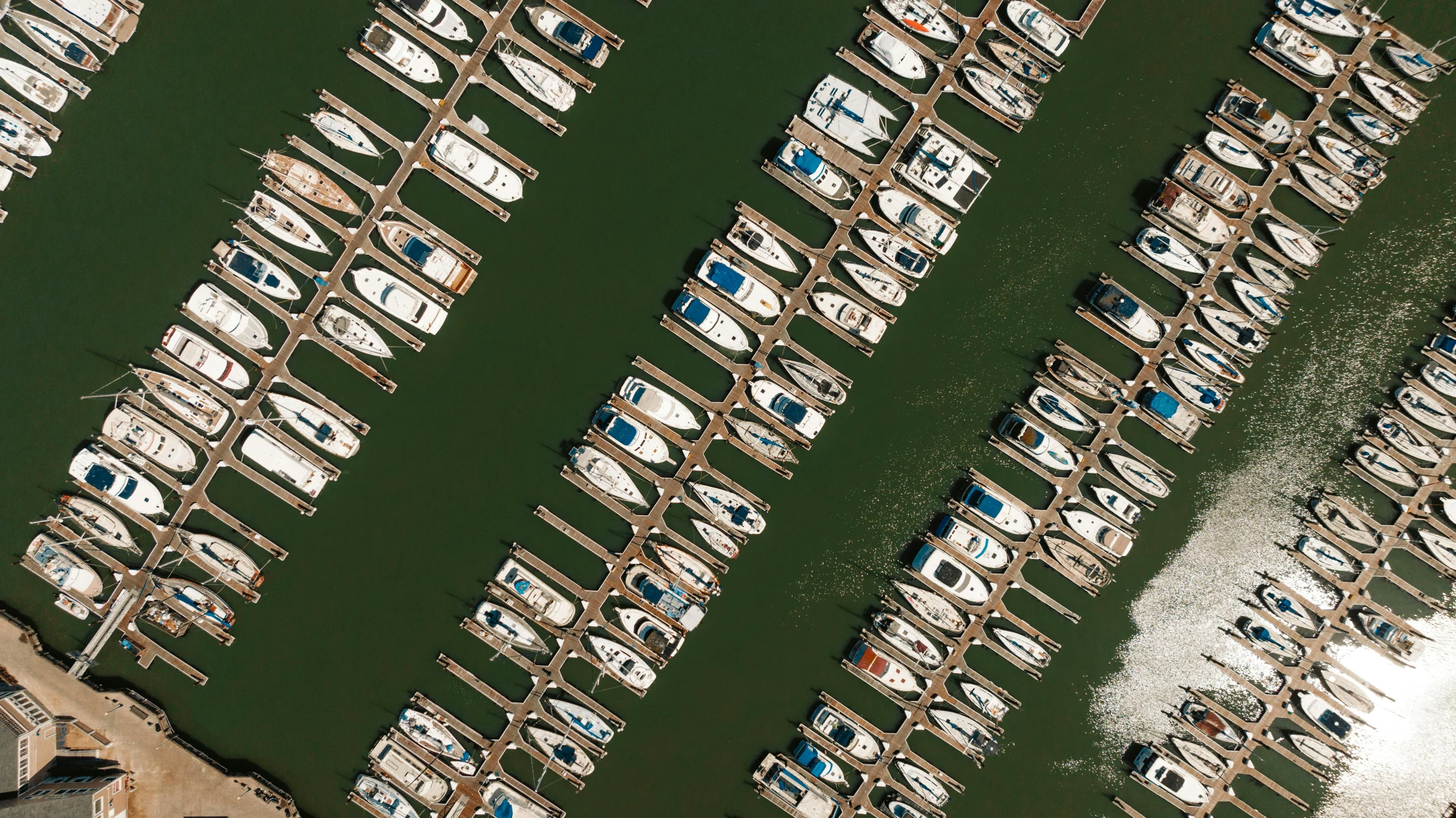 small white boats docked at a dock near some docks