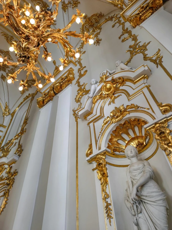 a large clock hanging from the side of a white wall