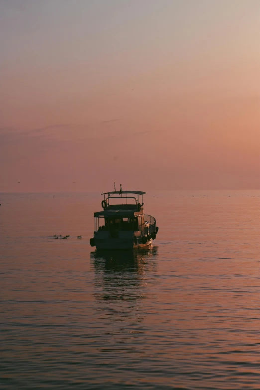 two boats are floating across the water near one another