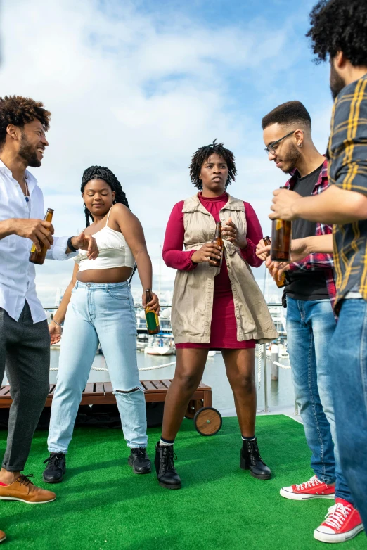 five friends are standing on a boat having drinks