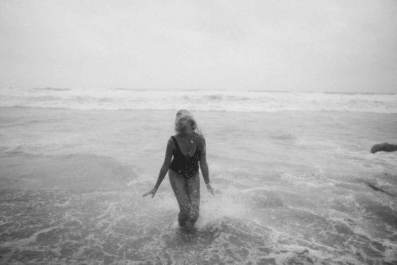 a person is wading in the ocean waters