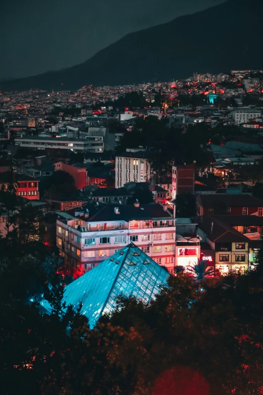 a night view of some buildings and the mountain